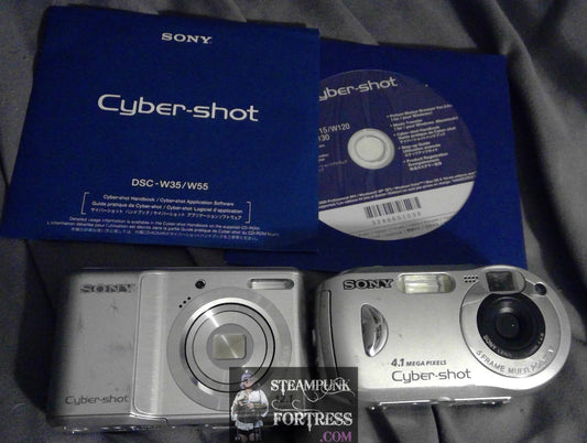 LOT OF 2 SONY CYBERSHOT CAMERAS SILVER BODY NOT WORKING PARTS ONLY CD DSC W35